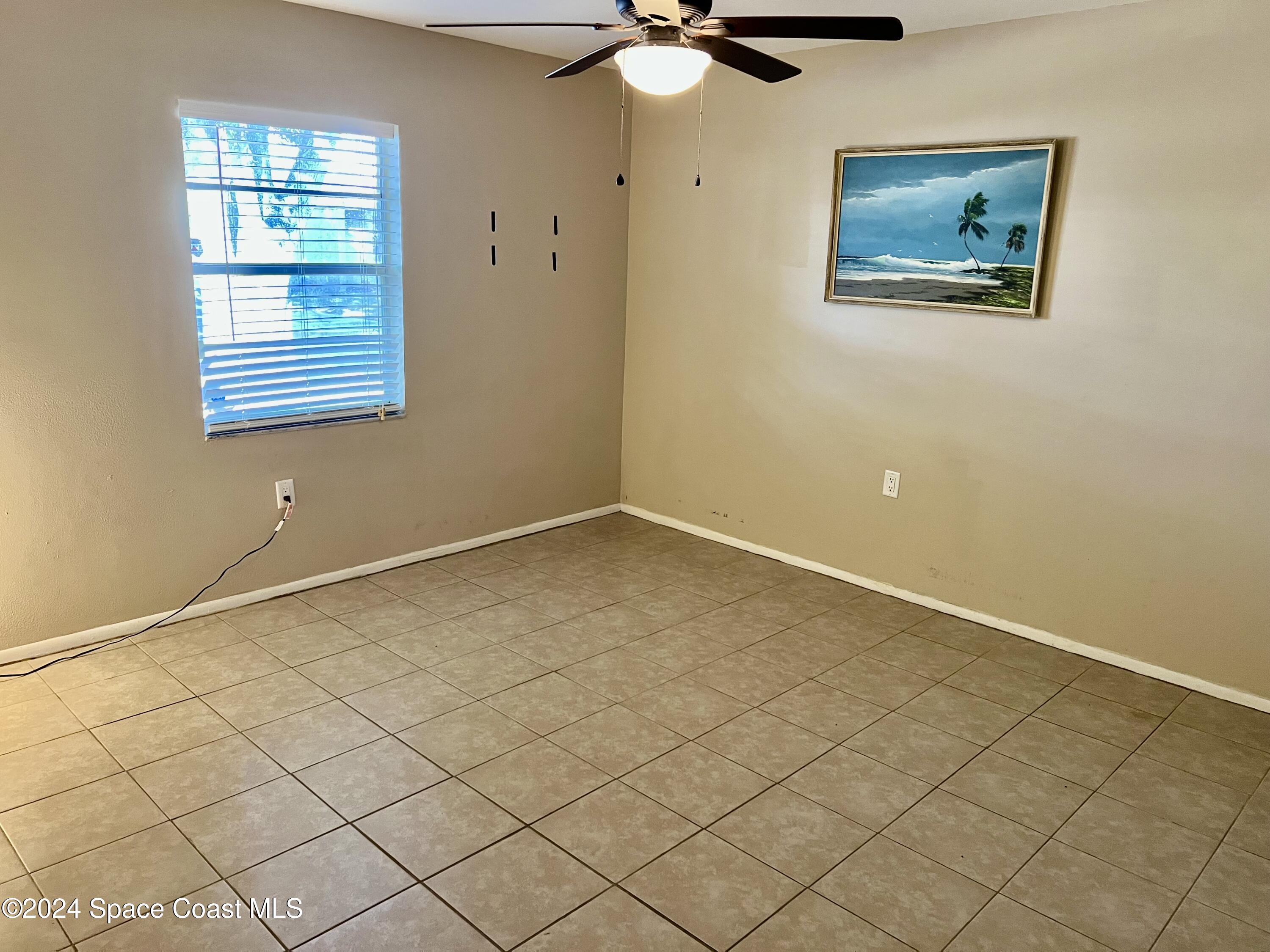 3225 Murrell Road, Unit 12 Rockledge, FL 32955 - Photo 5 of 14 a view of an empty room with a window