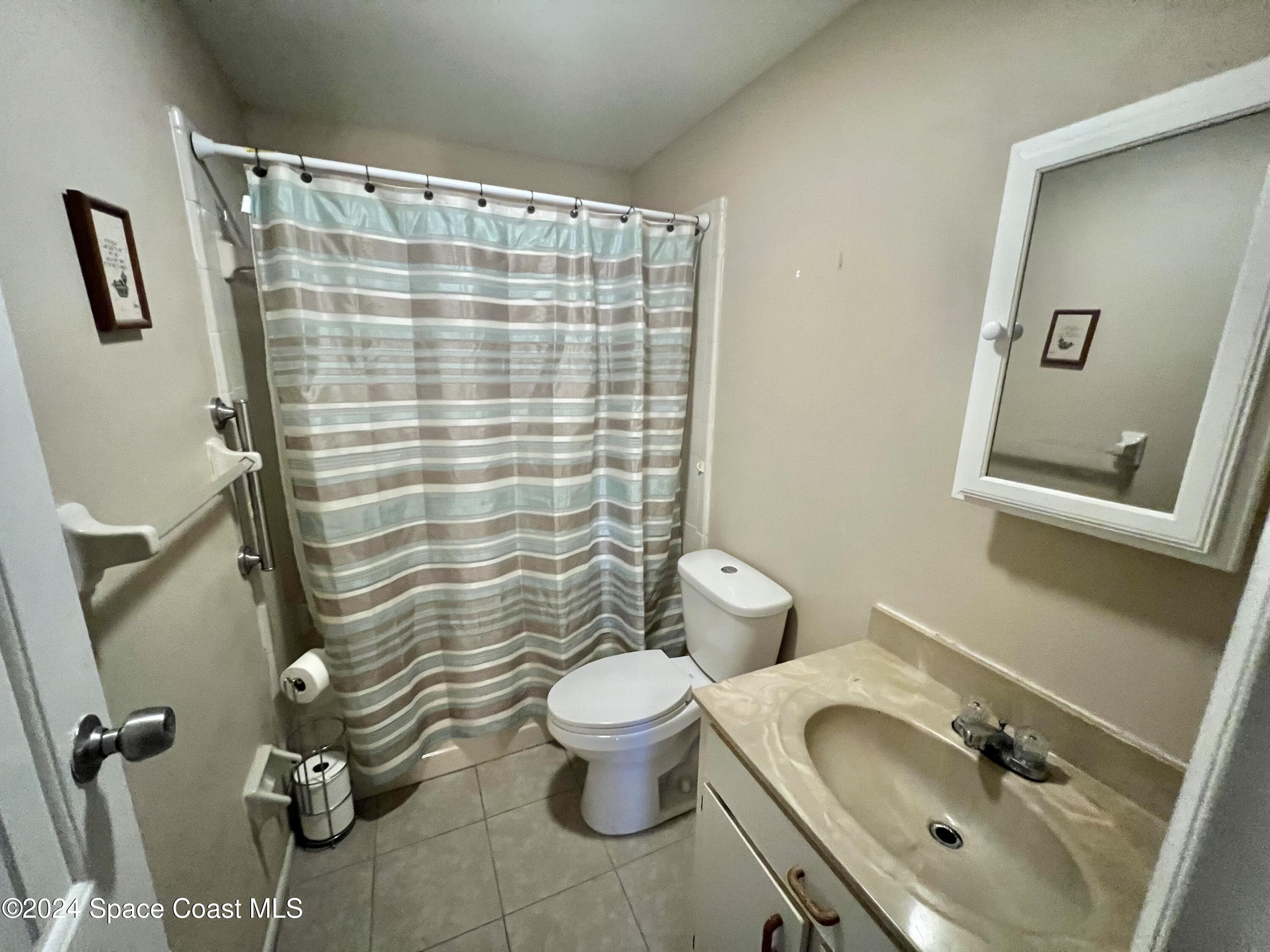 3225 Murrell Road, Unit 12 Rockledge, FL 32955 - Photo 8 of 14 a bathroom with a sink toilet and shower