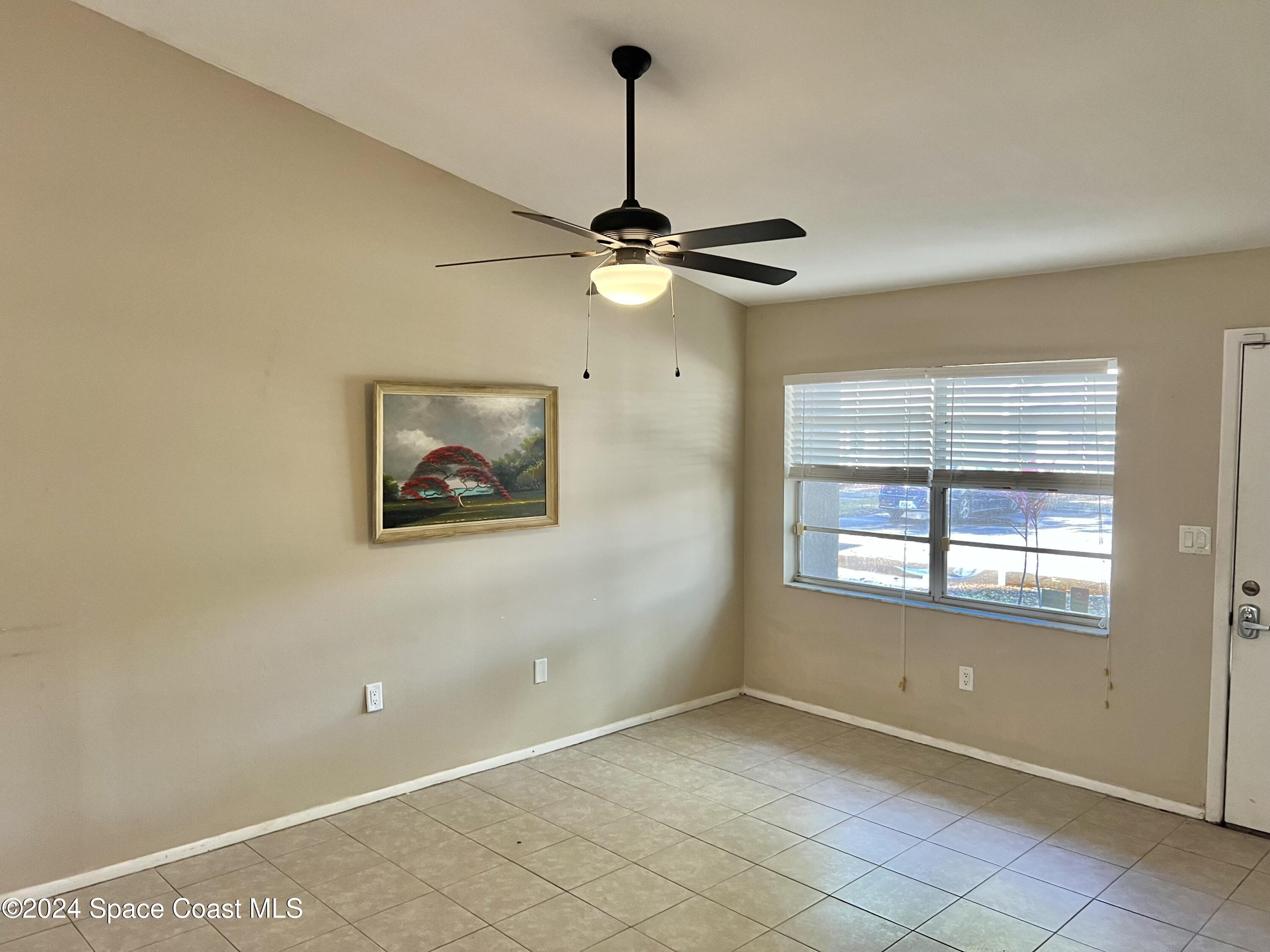 3225 Murrell Road, Unit 12 Rockledge, FL 32955 - Photo 9 of 14 a view of an empty room with a window