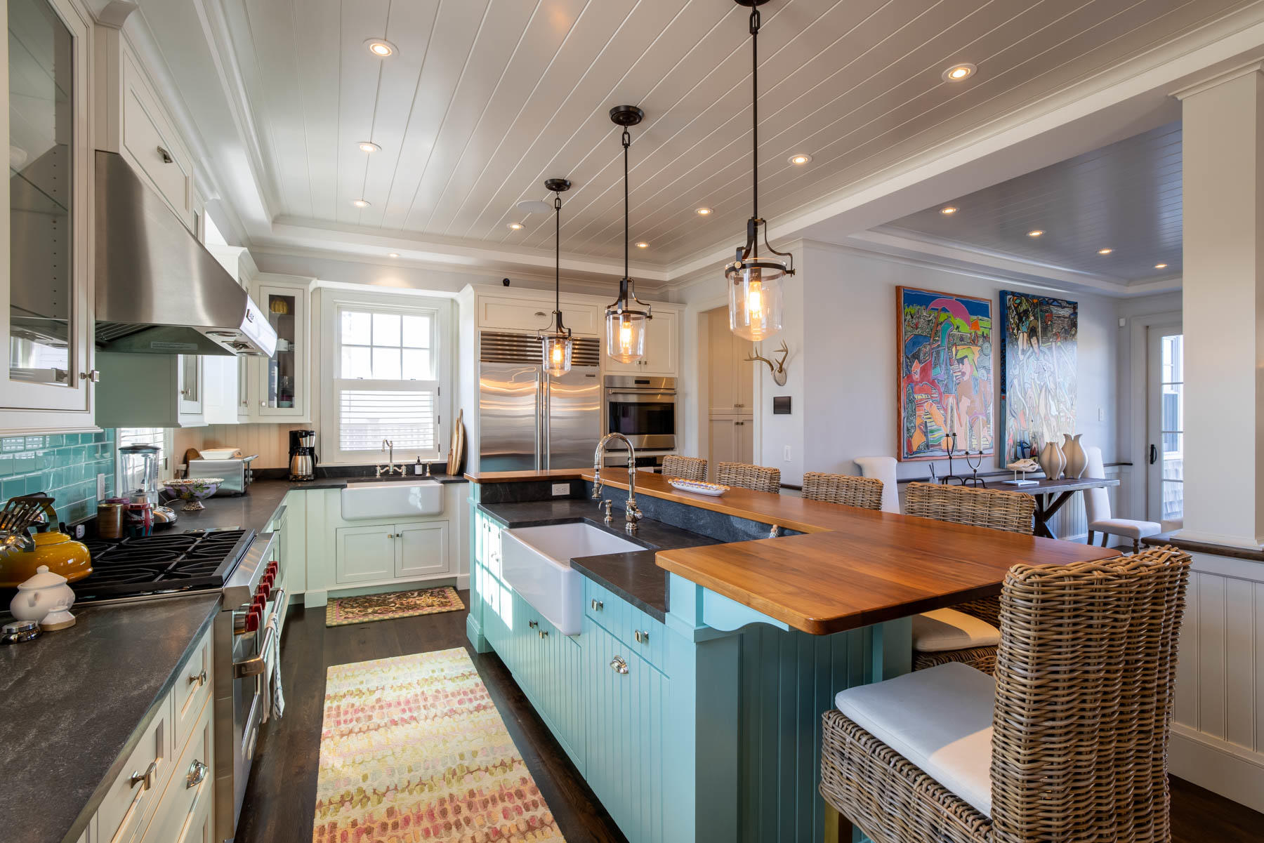 25 Pierce Lane Edgartown, MA 02539 - Photo 19 of 52 a kitchen with stainless steel appliances granite countertop a stove a sink dishwasher a dining table and chairs with wooden floor