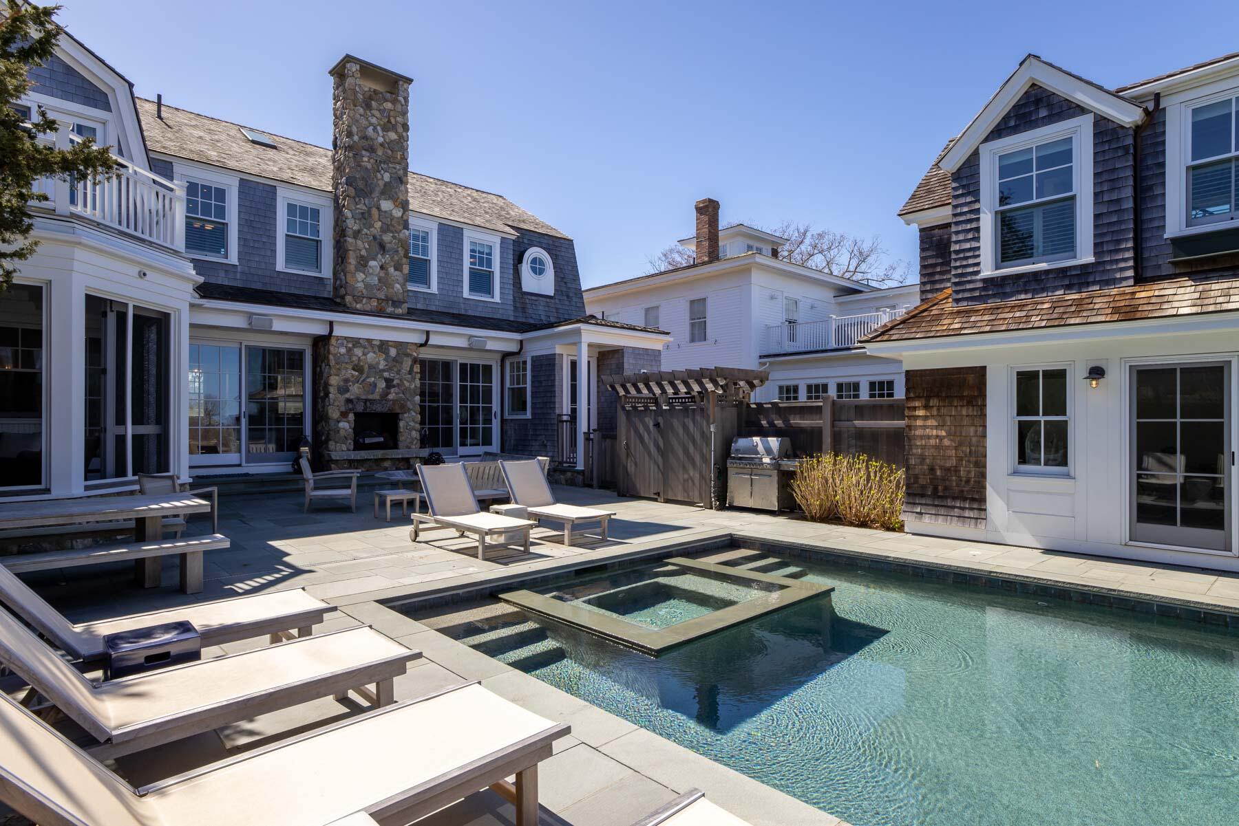 25 Pierce Lane Edgartown, MA 02539 - Photo 5 of 52 a view of a patio with couches table and chairs with wooden floor and fence