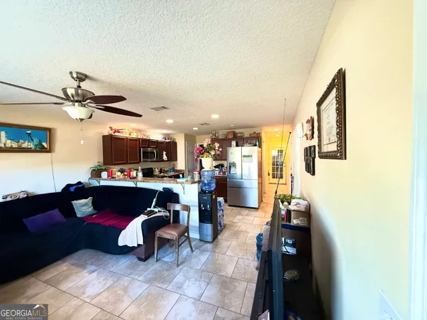 a kitchen with stainless steel appliances a refrigerator and a stove top oven
