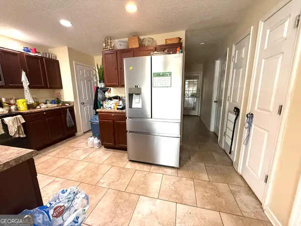 a kitchen with stainless steel appliances kitchen island granite countertop a refrigerator and a stove