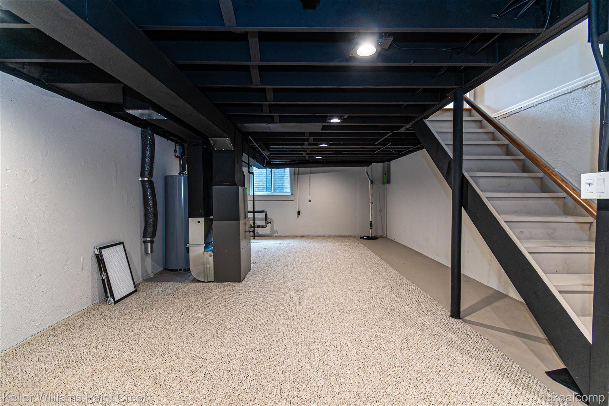 11401 Messmore Road Utica, MI 48317 - Photo 19 of 43 Spacious basement featuring light-toned carpeting and exposed black ceiling joists