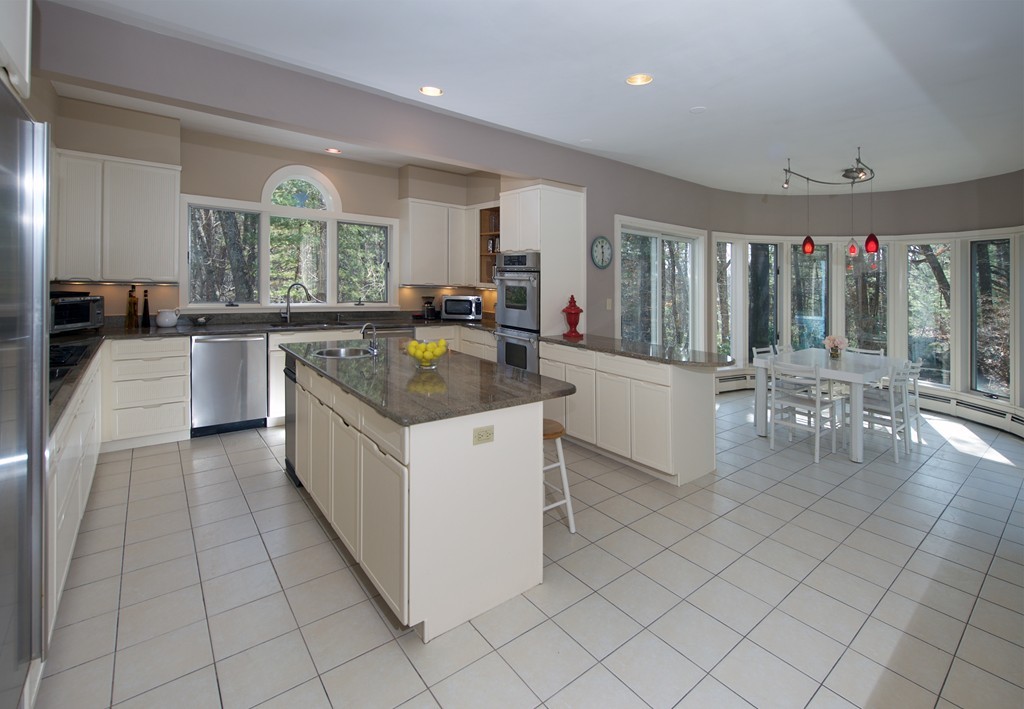 82 Sudbury Road Weston, MA 02493 - Photo 6 of 23 a kitchen with stainless steel appliances granite countertop a stove a sink and a refrigerator