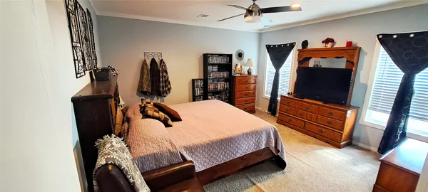 a bedroom with bed and wooden floor
