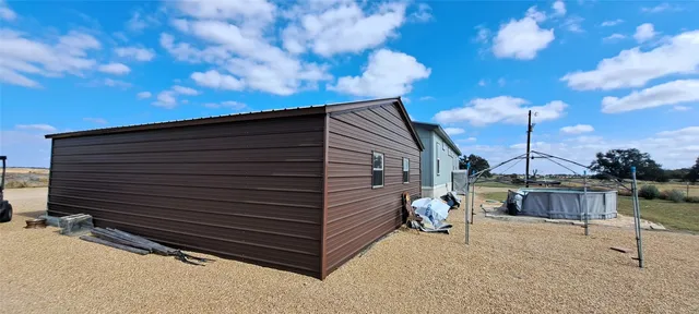 a view of backyard with sitting area