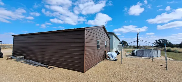 a view of backyard with sitting area