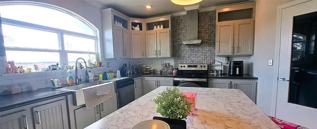 a kitchen with a refrigerator and a sink