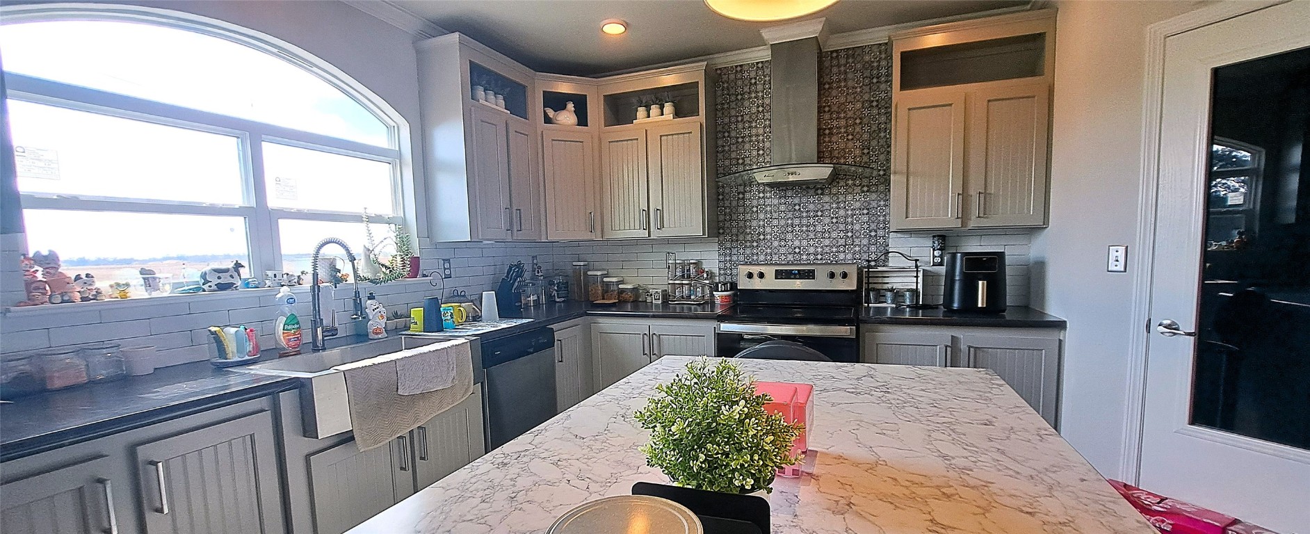 3432 County Road 206 Cameron, TX 76520 - Photo 29 of 39 a kitchen with kitchen island granite countertop a sink cabinets stainless steel appliances and a large window