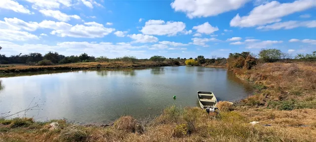 a view of a lake with houses in the back