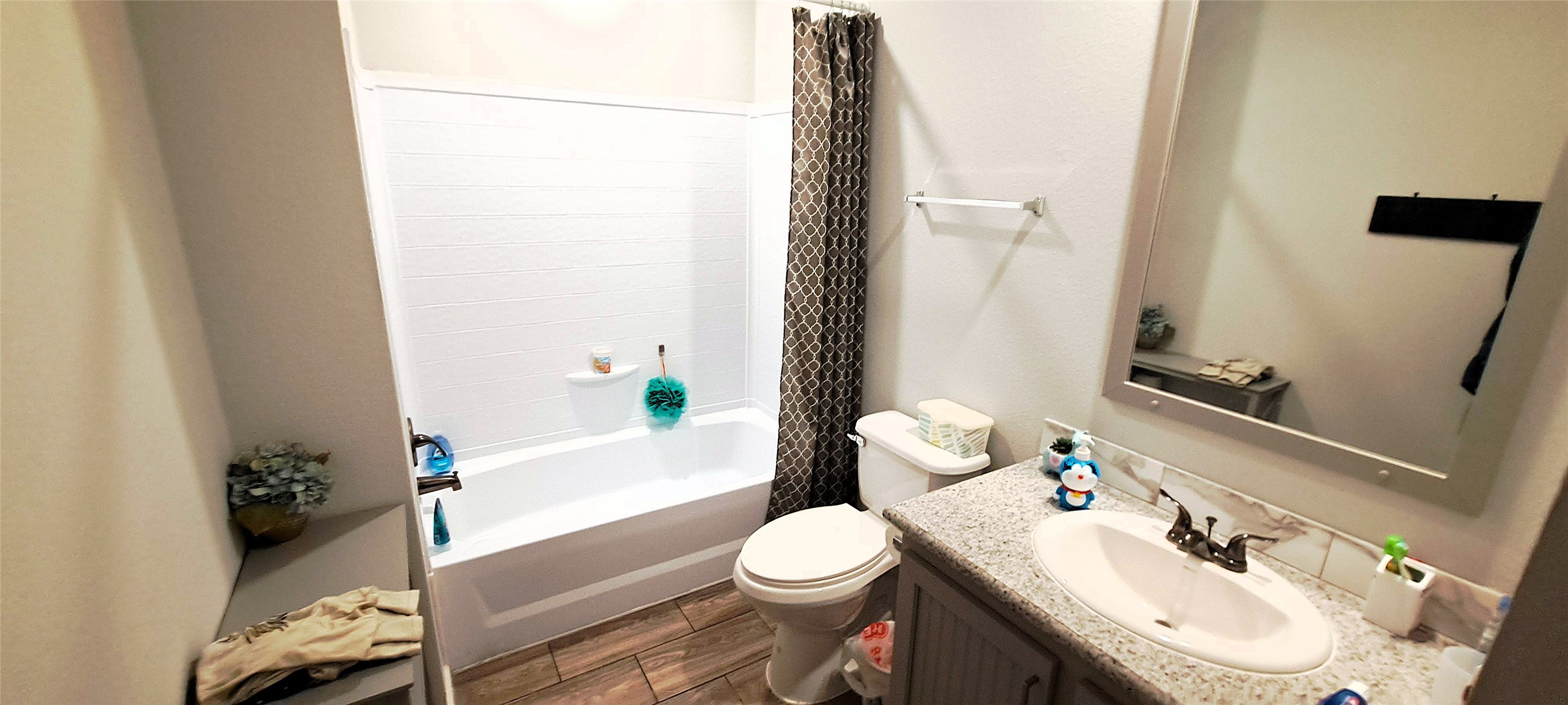3432 County Road 206 Cameron, TX 76520 - Photo 33 of 39 Bathroom featuring vanity, shower / tub combo with curtain, and wood finish floors