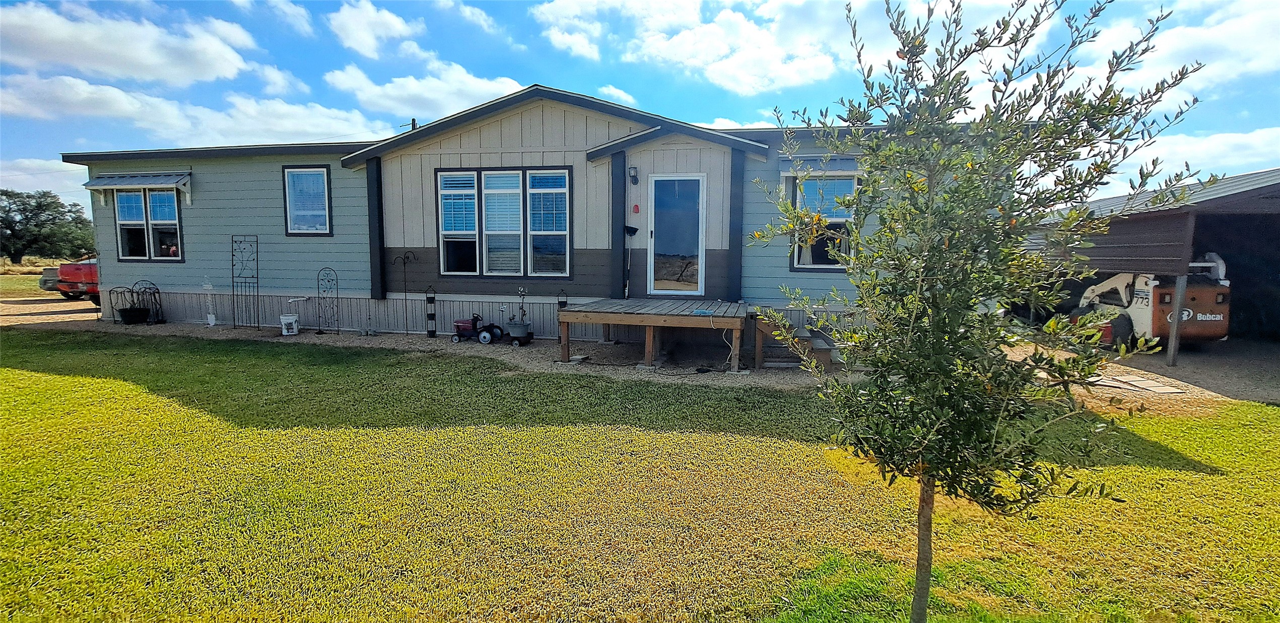 3432 County Road 206 Cameron, TX 76520 - Photo 4 of 39 Back of house with a lawn, a patio area, and board and batten siding