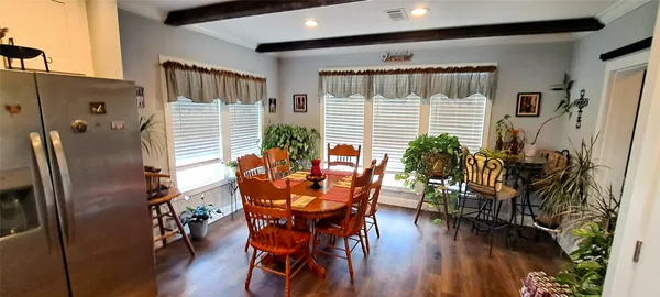 a dining room with furniture and wooden floor