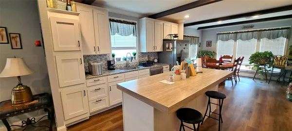 a kitchen with stainless steel appliances granite countertop a sink a stove and a refrigerator