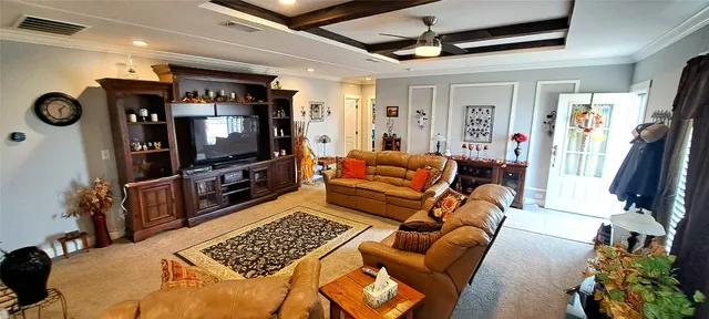 a living room with furniture a flat screen tv and gym equipment