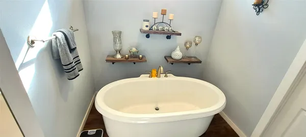 a bathroom with a sink and mirror with bathtub