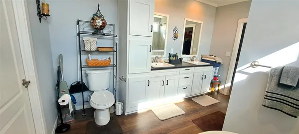 a bathroom with a toilet sink and mirror
