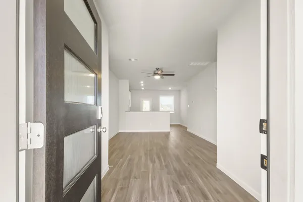 a view of a hallway with wooden floor