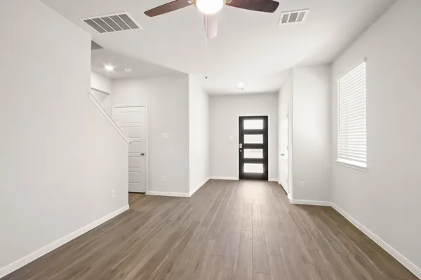 wooden floor in an empty room with a window
