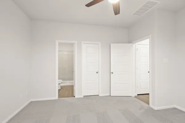 an empty room with window and ceiling fan