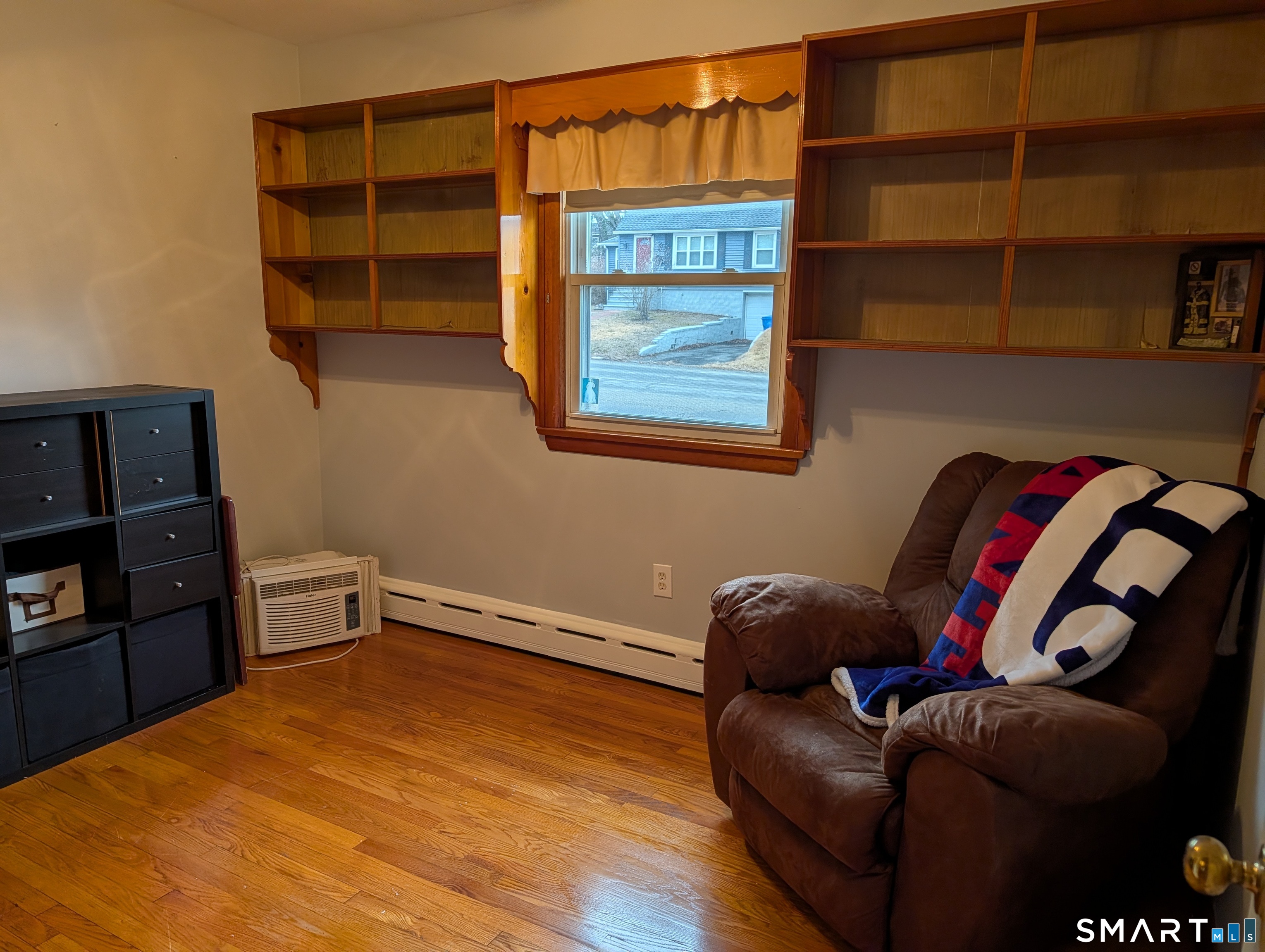 90 Hunthill Road Waterbury, CT 06705 - Photo 15 of 15 a blue bed sitting in a bedroom next to a cabinet with a book shelf