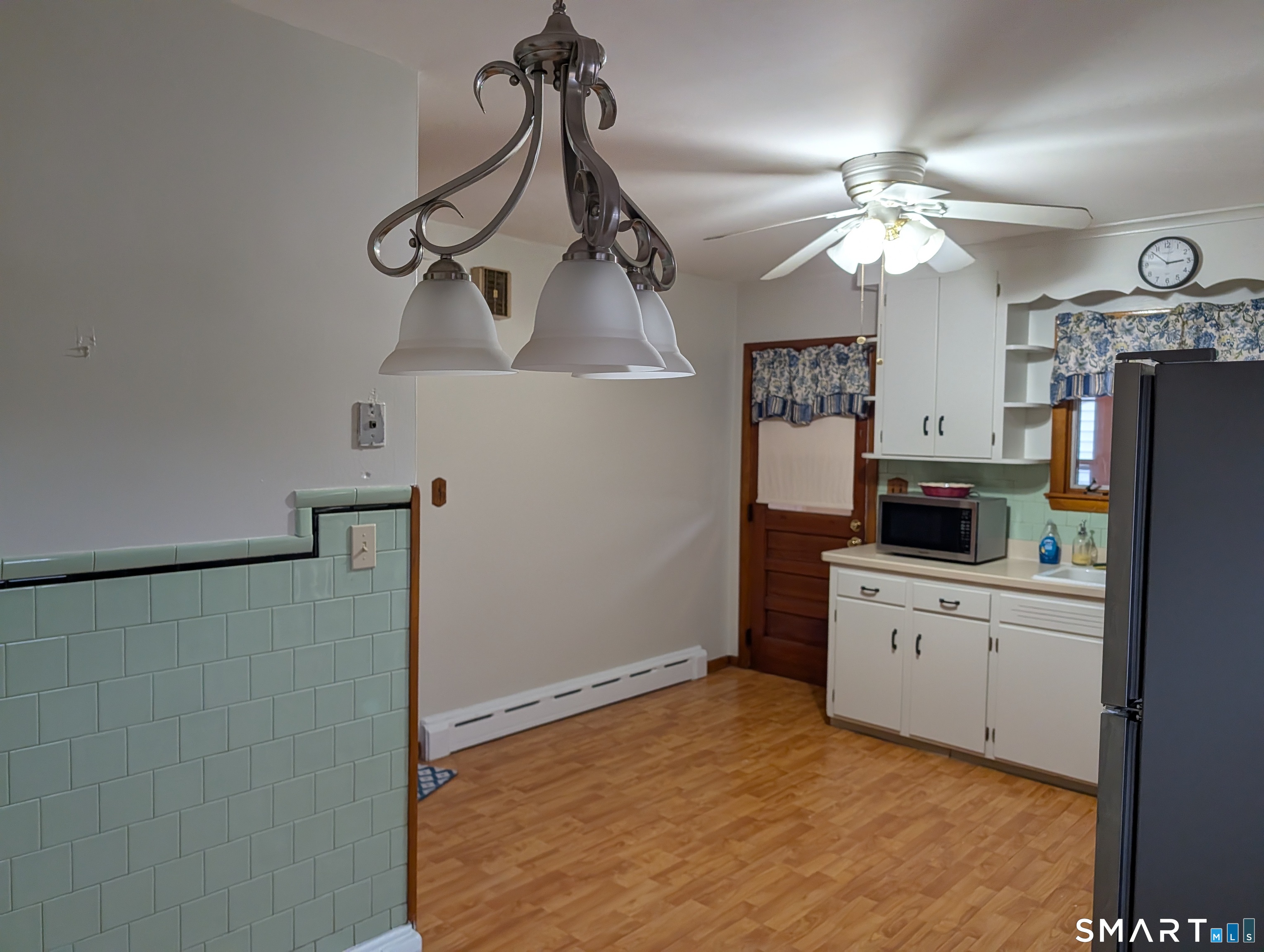90 Hunthill Road Waterbury, CT 06705 - Photo 7 of 15 a kitchen with stainless steel appliances a refrigerator and a chandelier