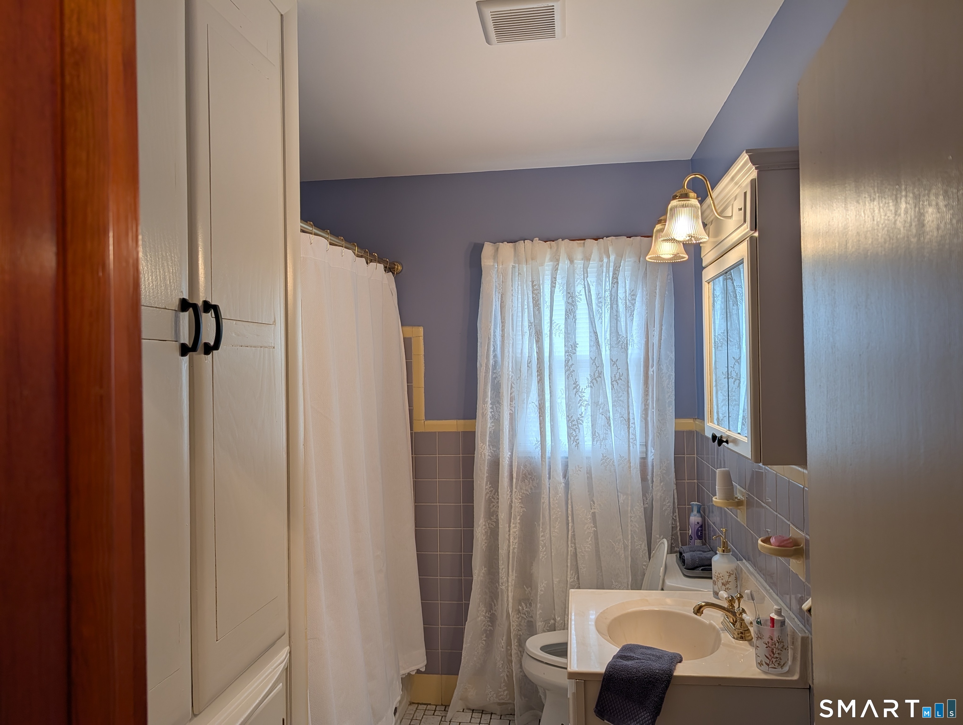 90 Hunthill Road Waterbury, CT 06705 - Photo 10 of 15 a bathroom with a sink and a mirror