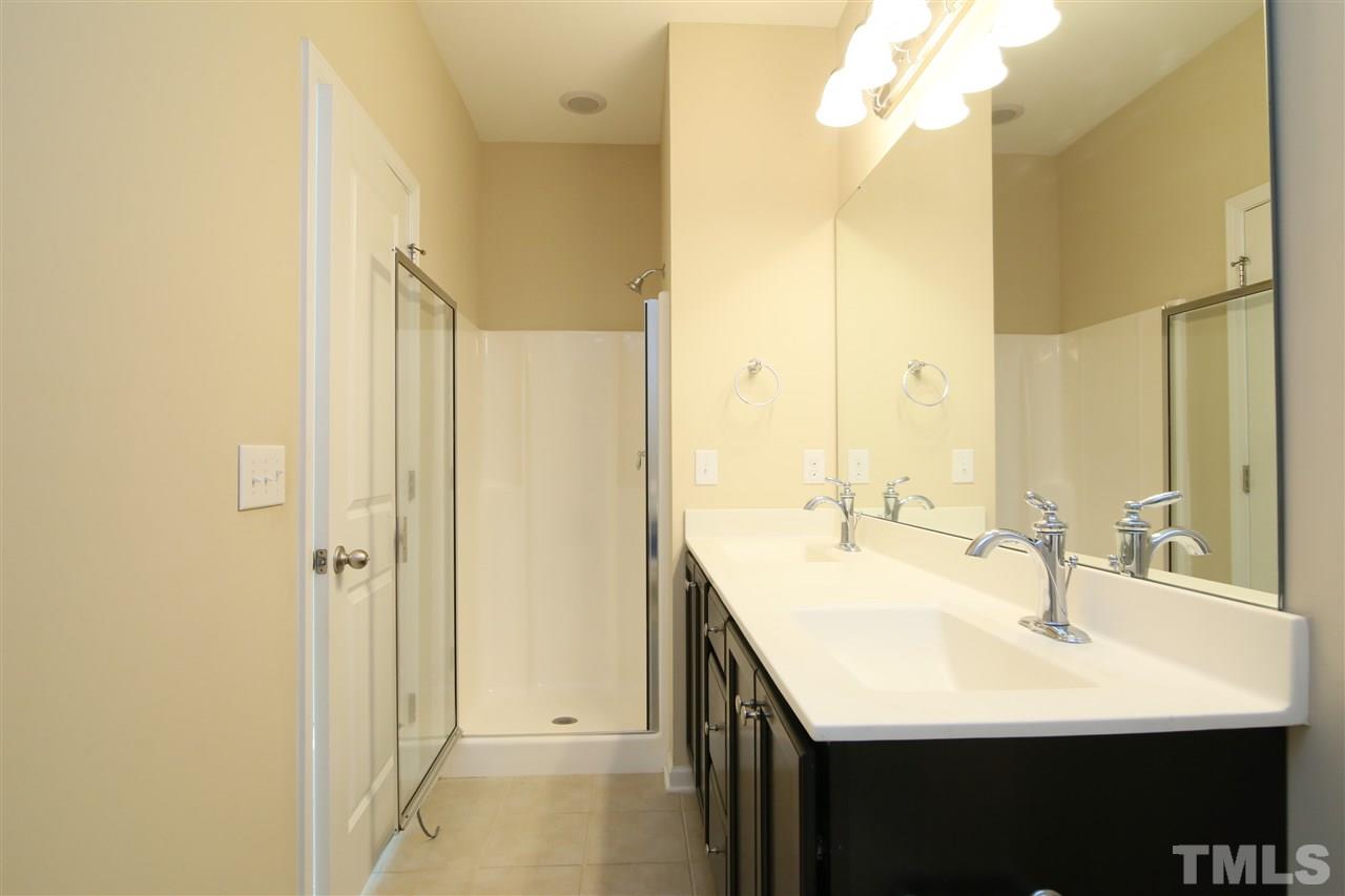 728 Wickham Ridge Road Apex, NC 27539 - Photo 11 of 21 a bathroom with a sink and a mirror