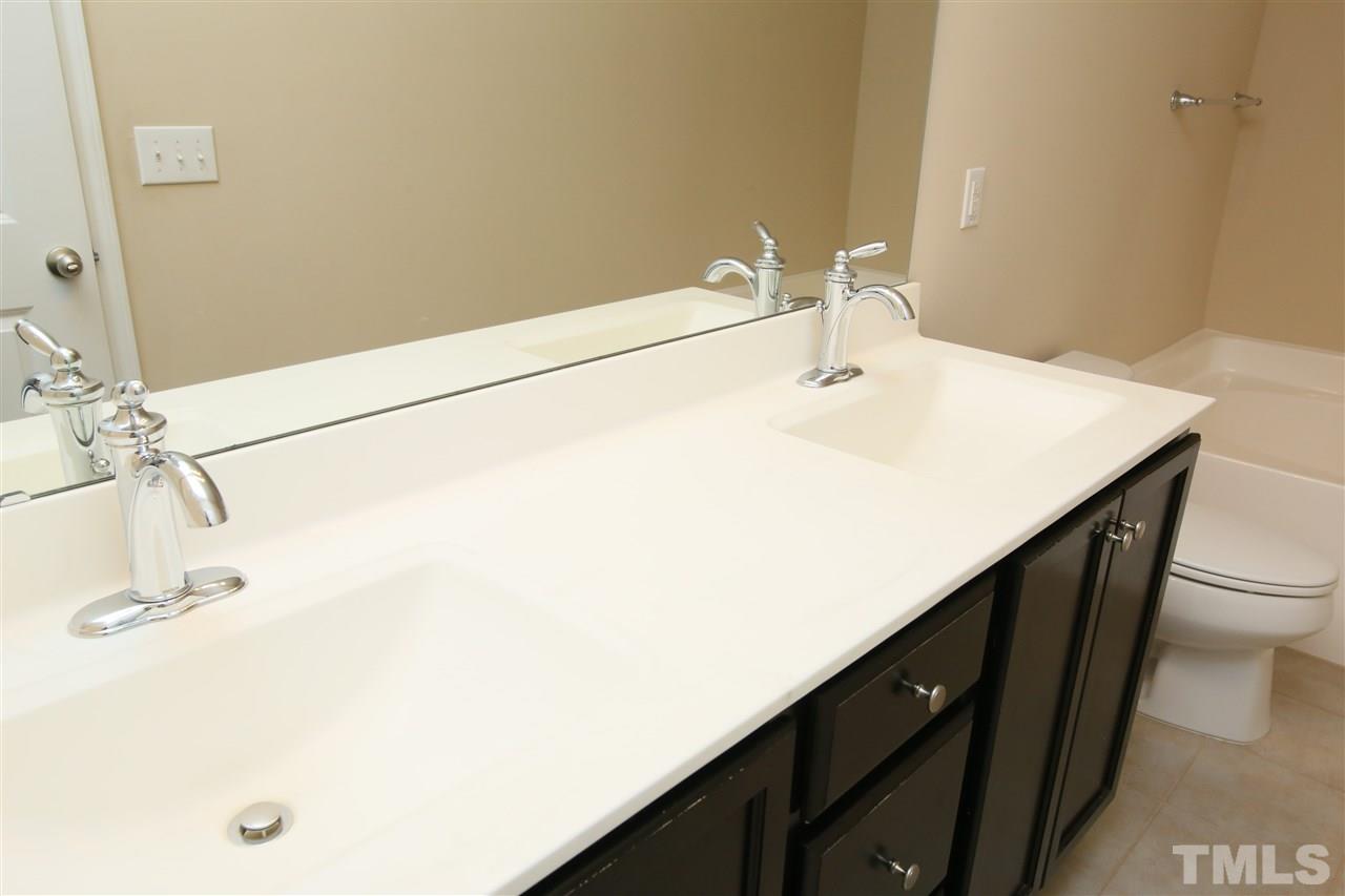 728 Wickham Ridge Road Apex, NC 27539 - Photo 12 of 21 a bathroom with a sink and a mirror