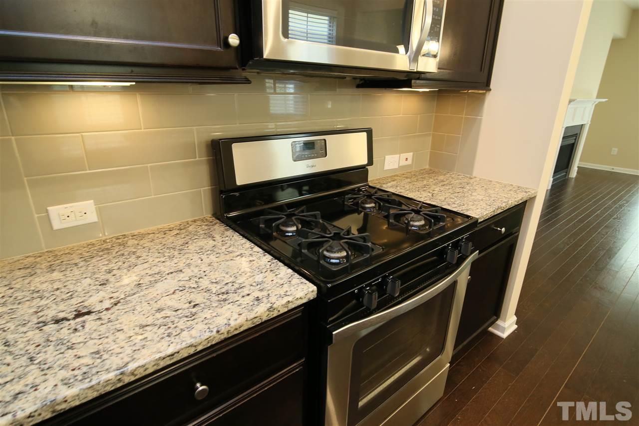 728 Wickham Ridge Road Apex, NC 27539 - Photo 6 of 21 a stove top oven sitting inside of a kitchen