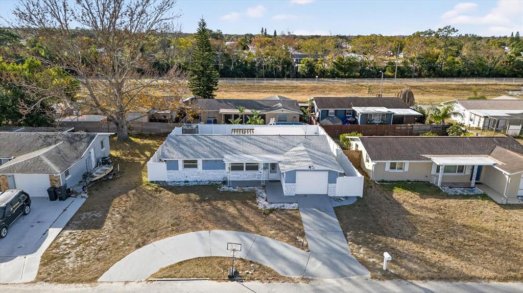 7814 Birchwood Drive Port Richey, FL 34668 - Photo 3 of 33 an aerial view of a house with a lake view