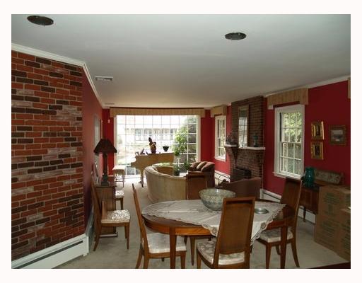 115 Hartshorn Road Providence, RI 02906 - Photo 2 of 5 Living Room. Oversized living/dining area with brick fireplace