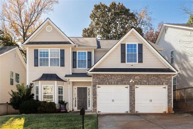a front view of a house with a yard