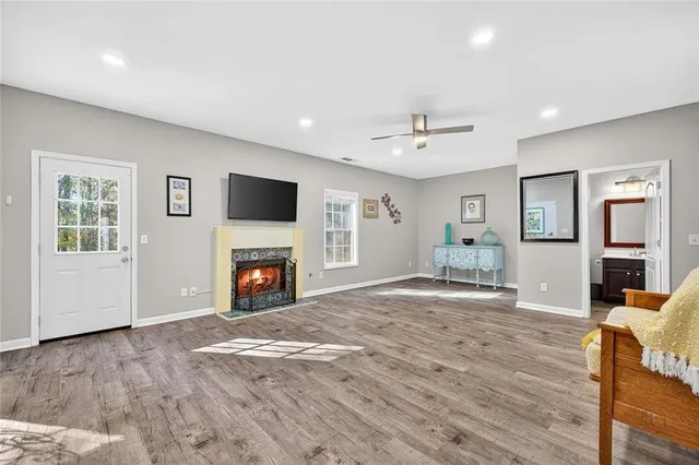 a view of a livingroom with a fireplace a window and a fireplace