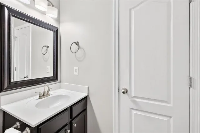 a bathroom with a sink vanity and a mirror
