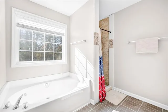 a bathroom with a bathtub and a shower
