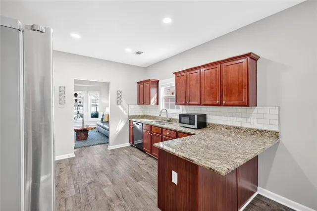 a kitchen with a stove a refrigerator and a sink
