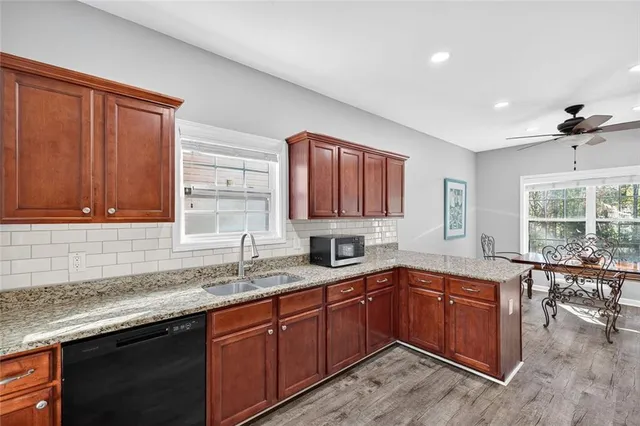a kitchen with a sink a window and cabinets