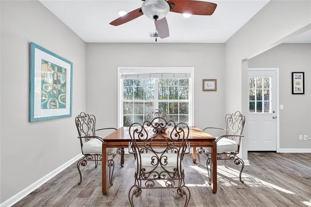 a view of a dining room with furniture window and wooden floor