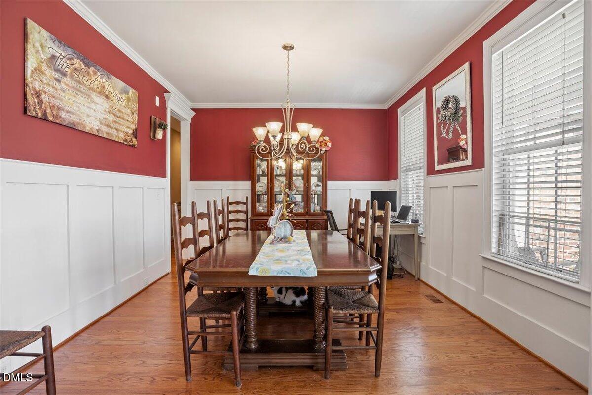 1001 Bellewood Farms Road Raleigh, NC 27603 - Photo 25 of 39 a view of a dining room with furniture window and wooden floor