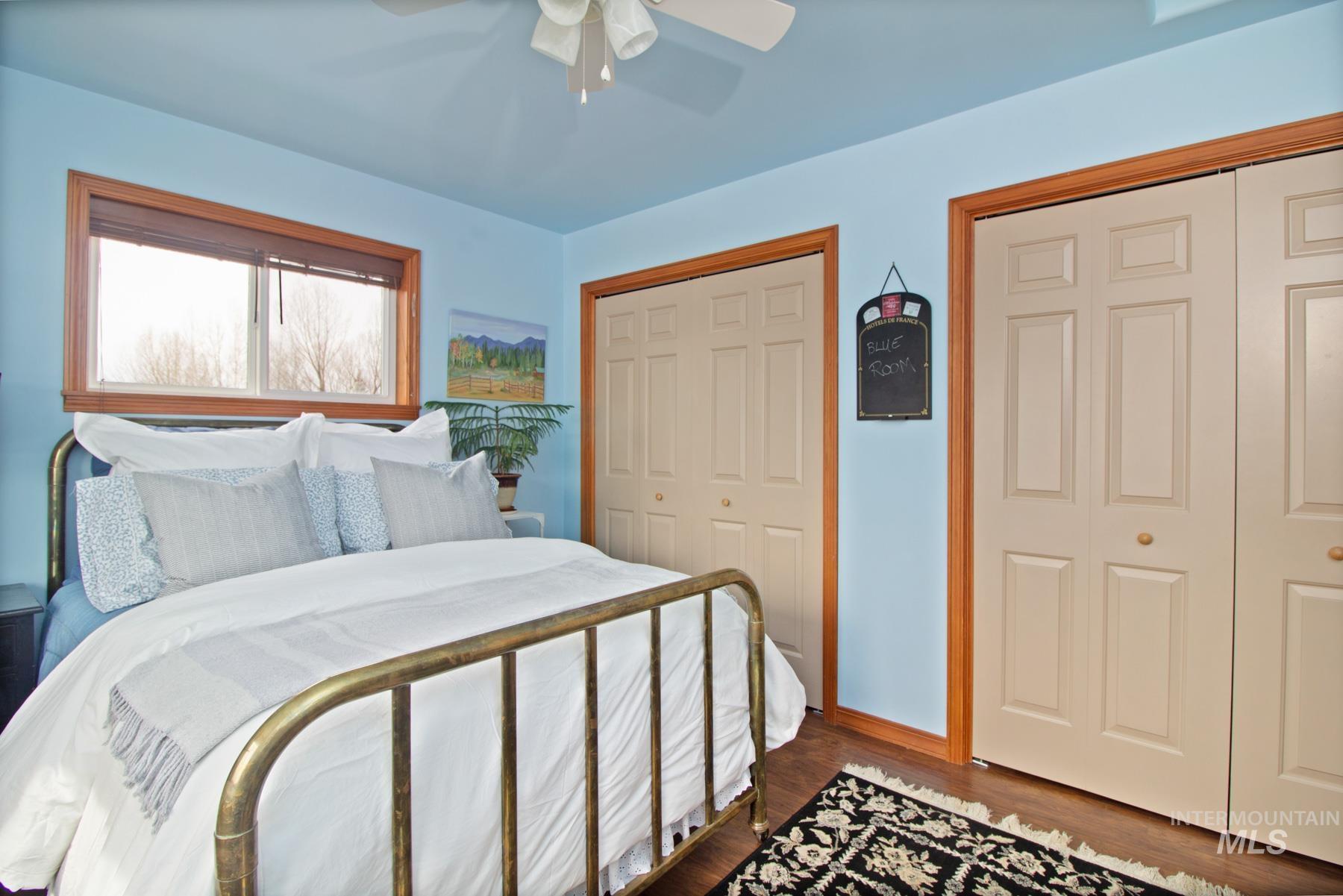 70 Tyler Drive Bellevue, ID 83313 - Photo 12 of 29 Bedroom featuring multiple closets, wood finished floors, and ceiling fan