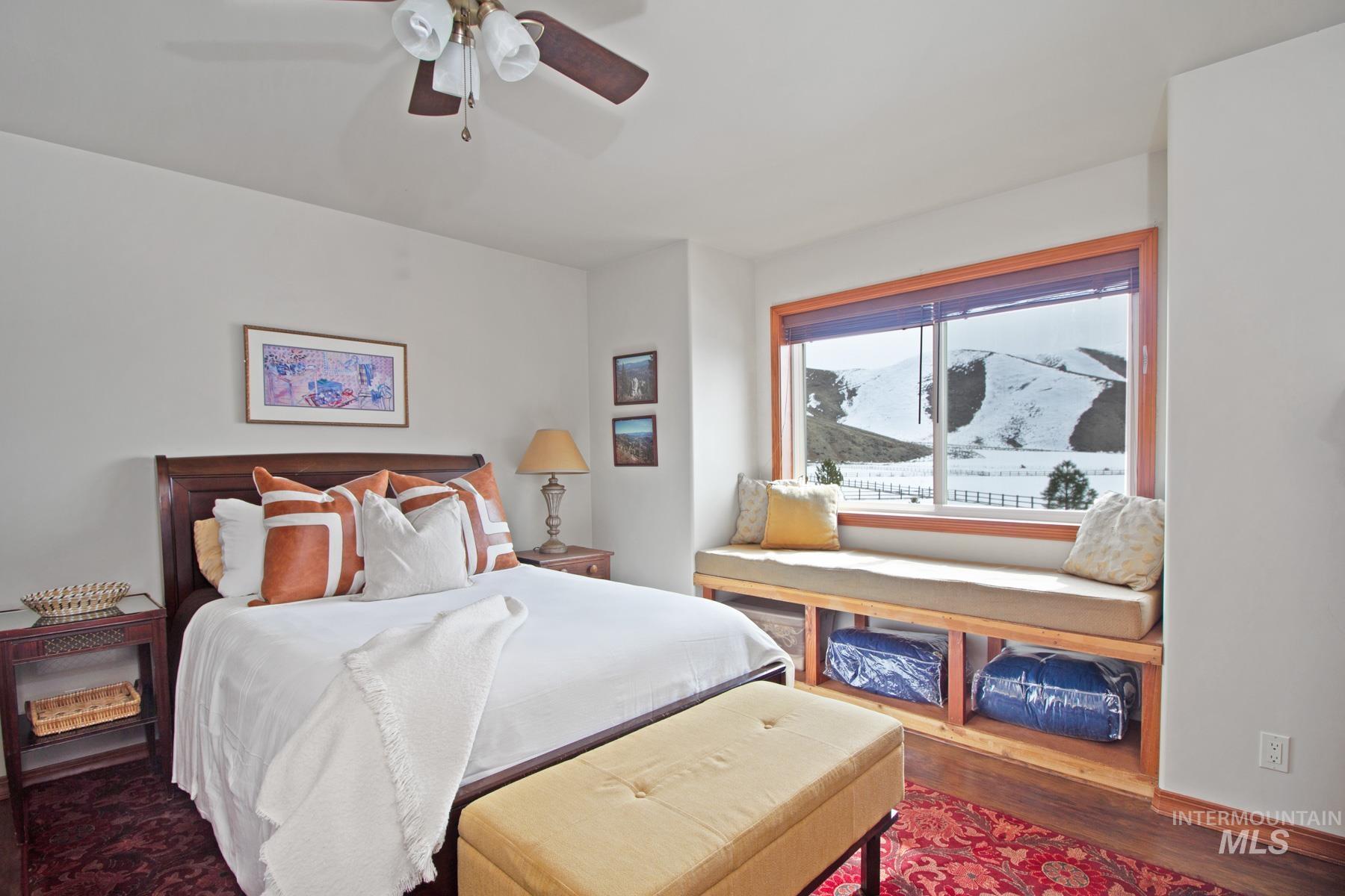 70 Tyler Drive Bellevue, ID 83313 - Photo 13 of 29 Bedroom with a ceiling fan, dark wood-type flooring, and a mountain view