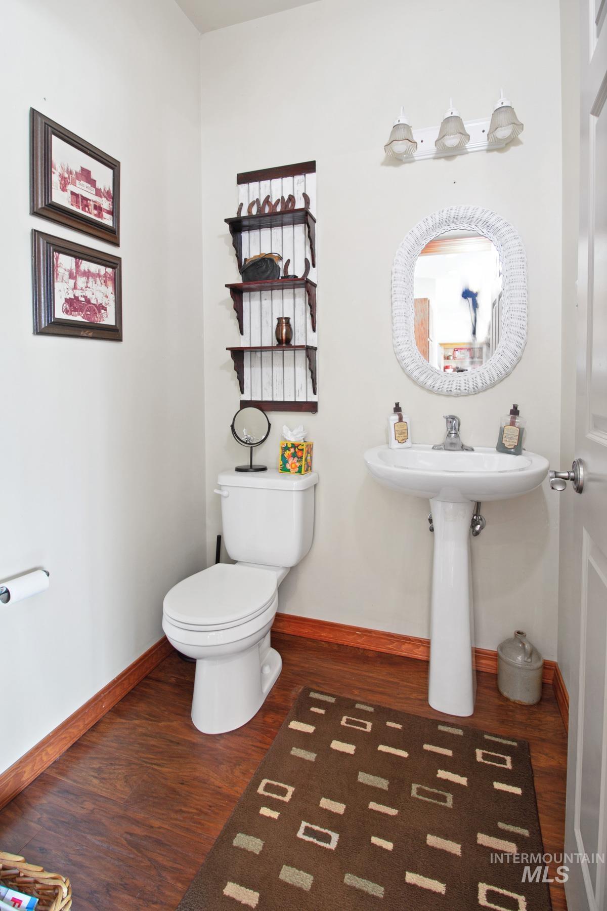 70 Tyler Drive Bellevue, ID 83313 - Photo 17 of 29 Half bathroom with dark wood-style flooring and toilet