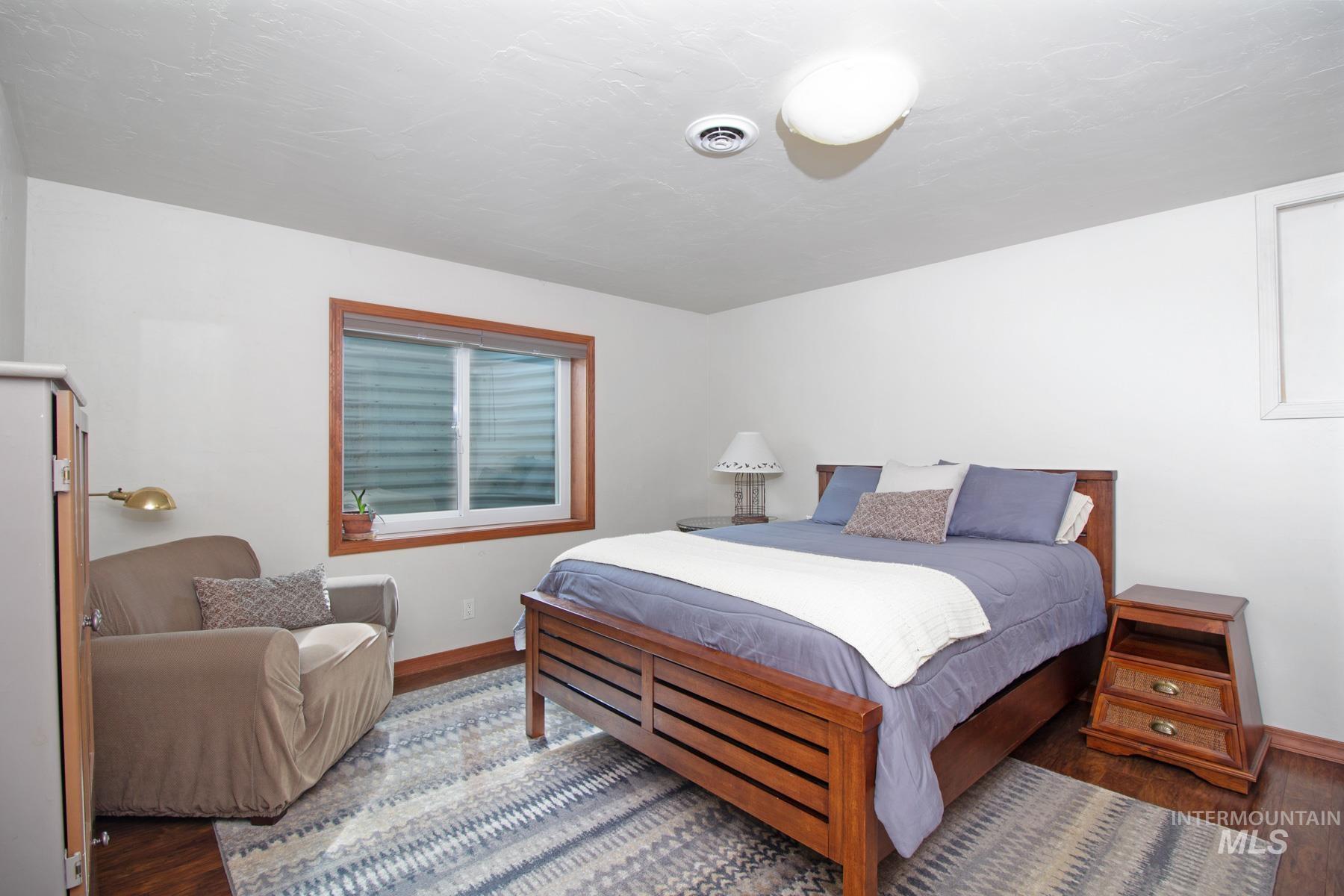 70 Tyler Drive Bellevue, ID 83313 - Photo 23 of 29 Bedroom with dark wood-style flooring and baseboards