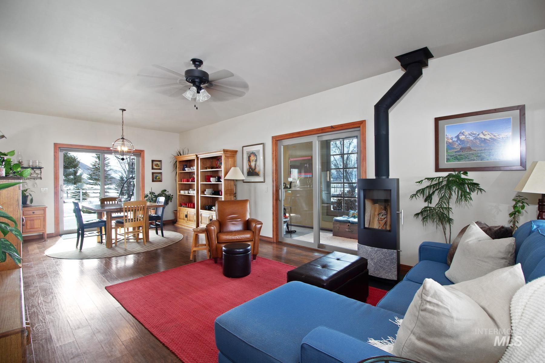 70 Tyler Drive Bellevue, ID 83313 - Photo 5 of 29 Living area featuring a wood stove, wood finished floors, and healthy amount of natural light