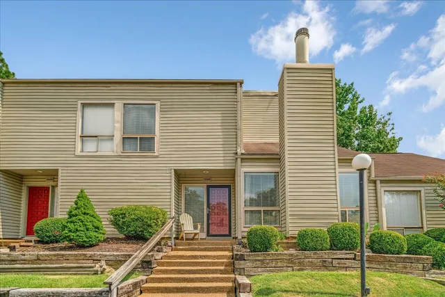 a view of a house with a yard and plants
