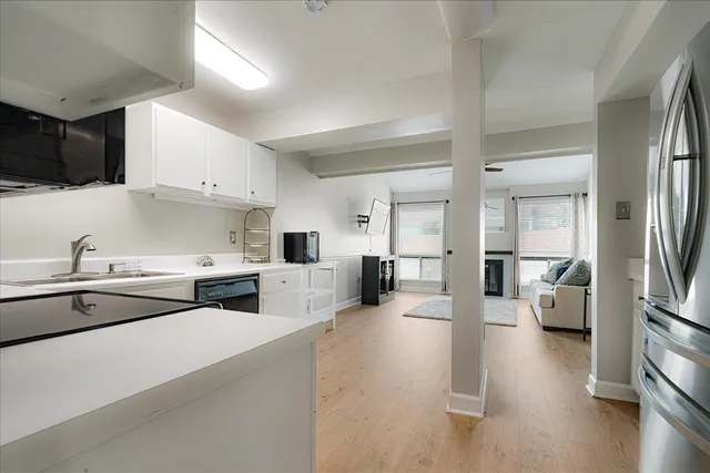 a kitchen with stainless steel appliances a sink a stove and a refrigerator