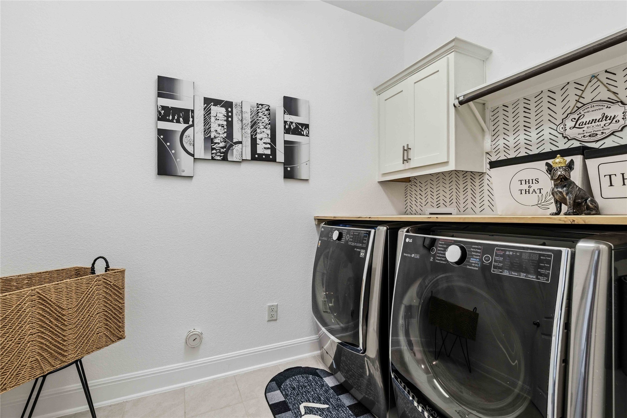 1517 Bardella Drive Leander, TX 78641 - Photo 18 of 40 Laundry area featuring light tile patterned floors, cabinet space, and independent washer and dryer