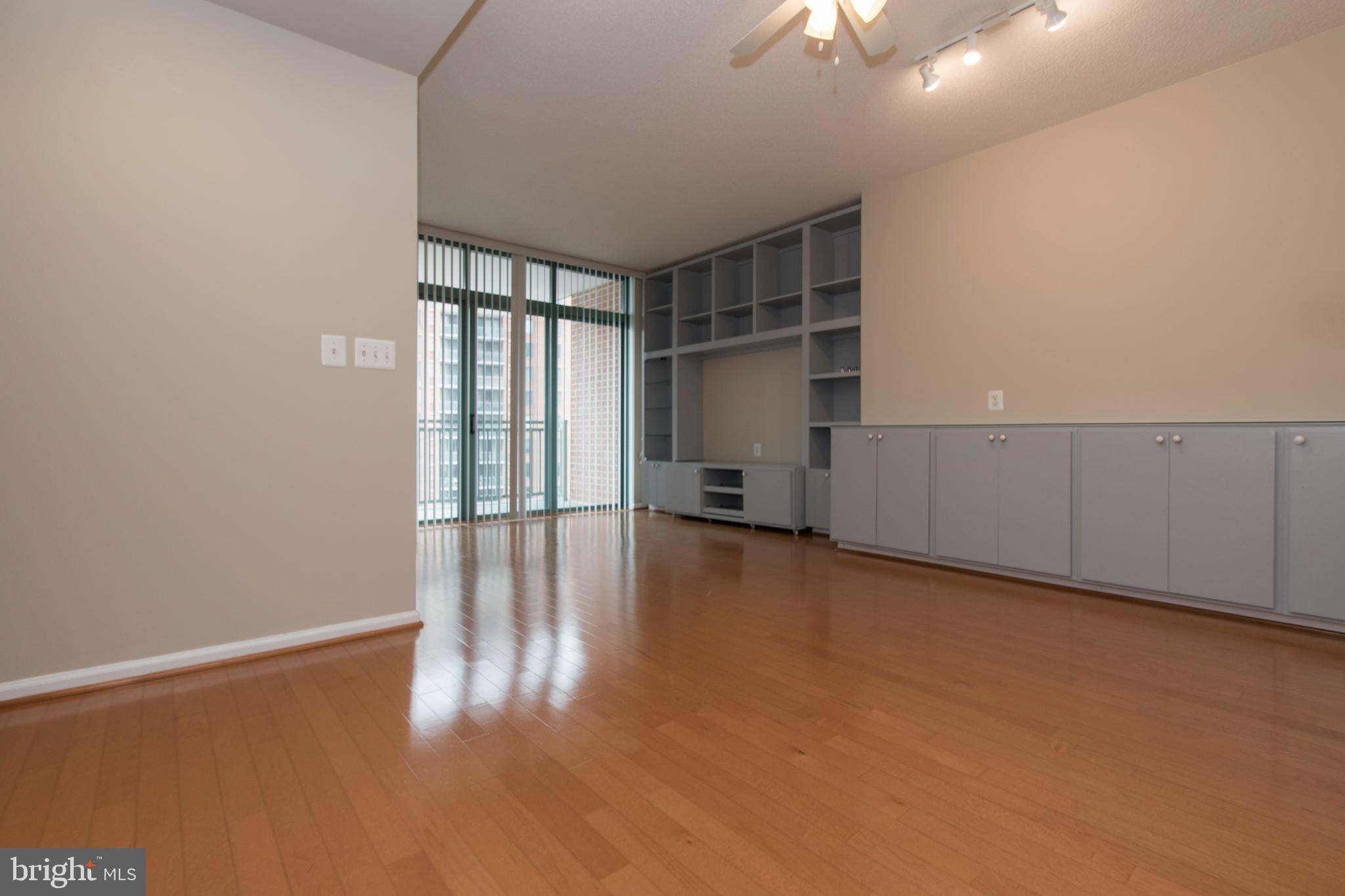 11700 Old Georgetown Road, Unit 807 North Bethesda, MD 20852 - Photo 13 of 37 an empty room with chandelier fan and windows